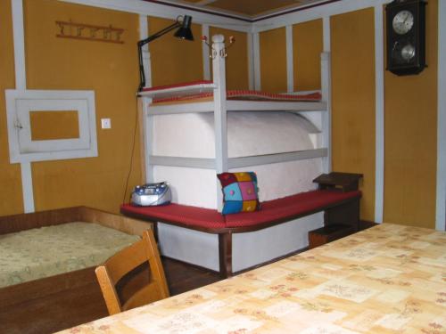 a room with two bunk beds and a table at Unser kleines Bauernhaus in Maria Luggau