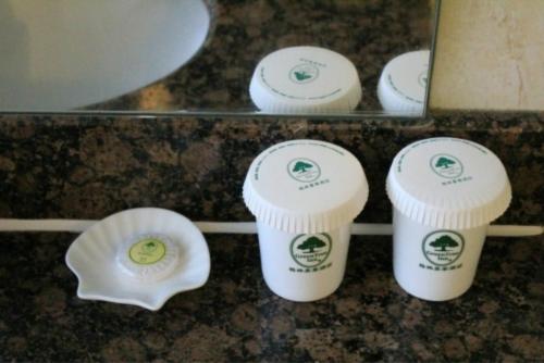 a group of cups sitting on a counter at GreenTree Inn Datong West Xiangyang Street Express Hotel in Datong