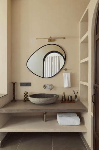 a bathroom with a sink and a mirror at Rawstone Luxury Villas Jaipur in Jaipur