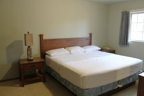 a bedroom with a bed and a lamp on a table at 2 Bedroom Condo at Wild Eagle Lodge, #232 in Eagle River