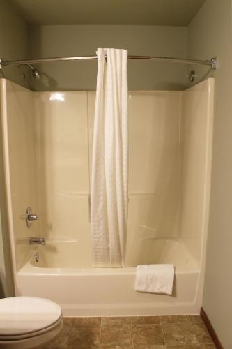 a bathroom with a tub and a toilet and a shower at 2 Bedroom Condo at Wild Eagle Lodge, #232 in Eagle River