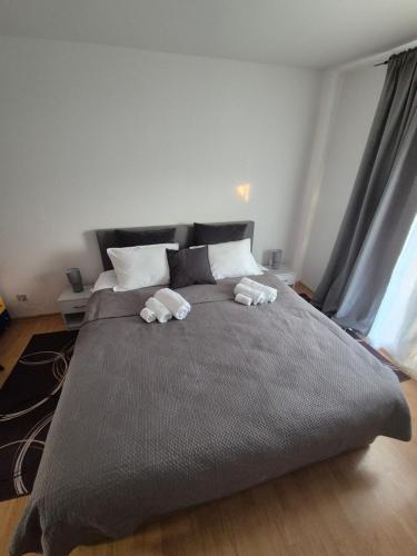 a bedroom with a large bed with two towels on it at Gajeva Rooms - Toronto apartment SELF CHECK-IN in Virovitica