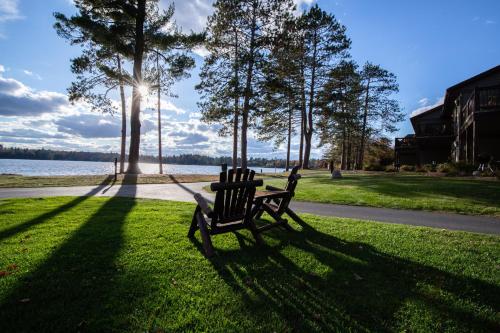 a park bench sitting in the grass next to a lake at 3 Bedroom condo at Wild Eagle Lodge in Eagle River