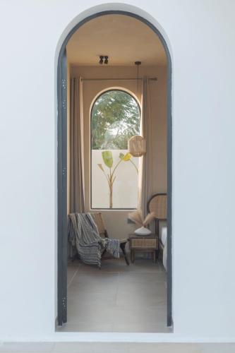 an archway leading into a living room with a window at Rawstone Luxury Villas Jaipur in Jaipur