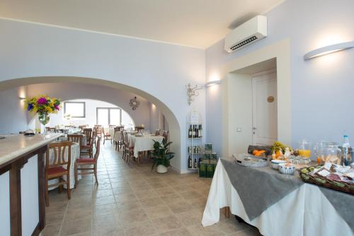 a restaurant with tables and chairs and a dining room at Fattoria Didattica La Collina Incantata in Narni