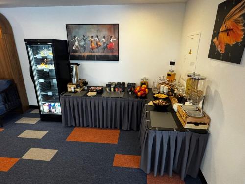 a room with two tables with food on it at Kepler Club Riga Airport Hotel - Landside Public Area in Rīga