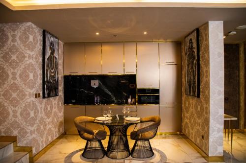 a dining room with a table and chairs at Number One Oxford Street Hotel & Suites in Accra