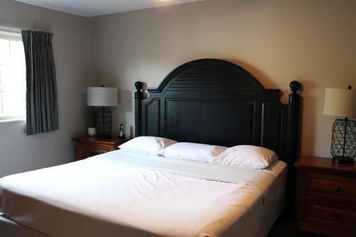 a bedroom with a large bed with white sheets and pillows at 3 Bedroom condo at Wild Eagle Lodge in Eagle River
