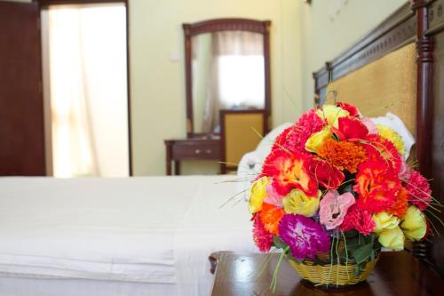 a bouquet of flowers in a basket on a table at AG Hotel Gondar in Gonder