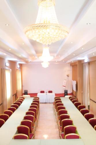 a large room with rows of chairs and a chandelier at AG Hotel Gondar in Gonder