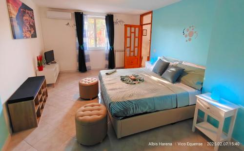 a bedroom with a large bed and a desk at Manù Apartment in Vico Equense