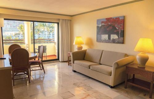 a living room with a couch and a table at Samba Vallarta All Inclusive in Nuevo Vallarta 