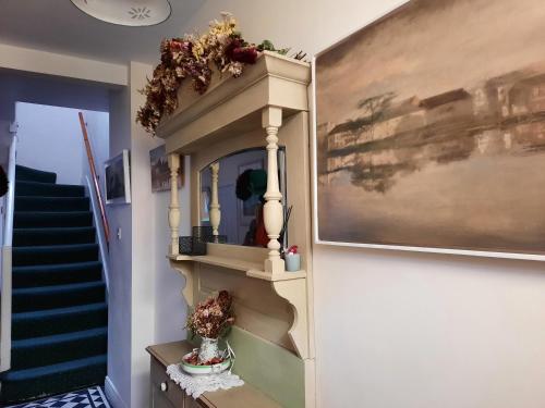 a stairwell with a shelf with flowers on it at City centre room Ensuite in Cork