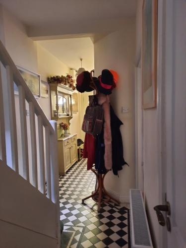 a mannequin in a hallway with hats on his head at City centre room Ensuite in Cork