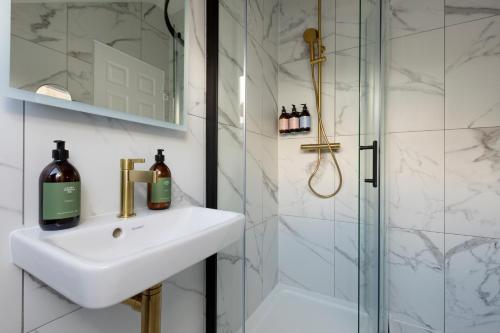 a bathroom with a sink and a shower at The Broughton Townhouse in Edinburgh
