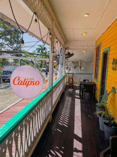a restaurant with a sign on the side of a building at Calipso Bocastown B&B in Bocas del Toro