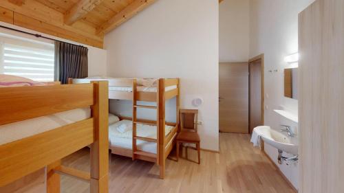 a room with two bunk beds and a sink at Haus Christine in Neukirchen am Großvenediger