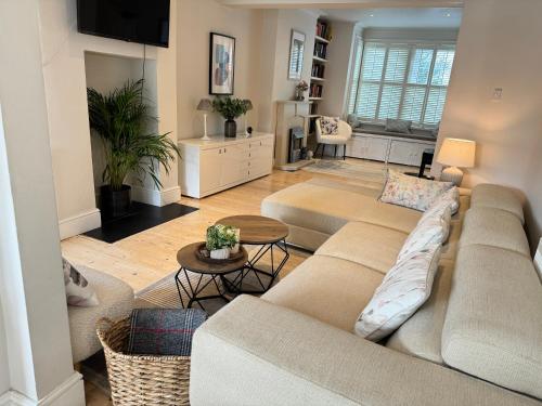 a living room with a couch and a table at Beautiful Victorian Home near central Oxford in Oxford