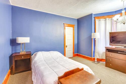 a blue bedroom with a bed and a tv at Historic Home with Yard in the Heart of Reading! in Reading