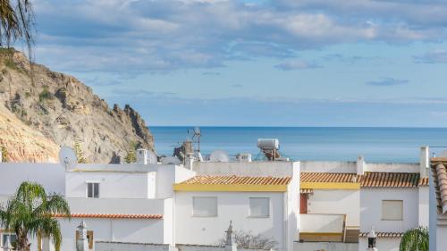 a white building with the ocean in the background at Casa Azure in Luz