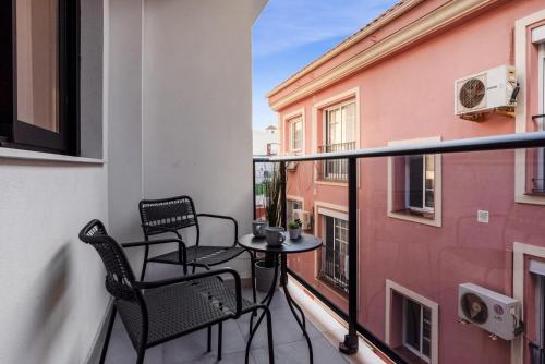 a balcony with two chairs and a table at ViVi Homes - Anemona , Beach , Balcony, Centre in Fuengirola