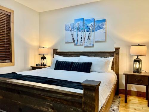 a bedroom with a bed with two lamps and two paintings at Luxury ADA Unit - 101 in Wilmington