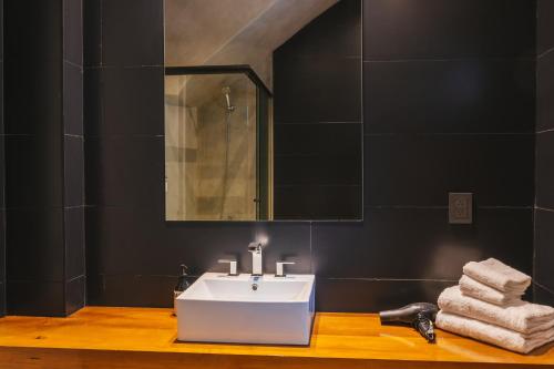 a bathroom with a white sink and a mirror at Main By Babel in Mendoza