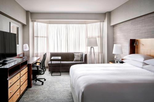 a hotel room with a large bed and a desk at San Francisco Marriott Union Square in San Francisco