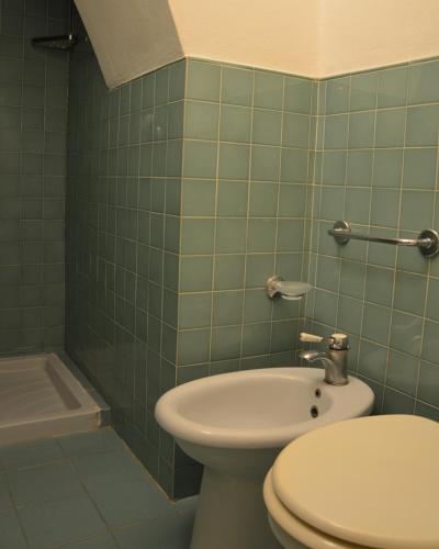 a bathroom with a toilet and a sink and a tub at La Casina Punta Ala in Punta Ala