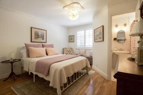 a bedroom with a bed with pink pillows at NEW Hugh St Hideaway with Pool in Jupiter