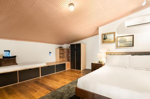 a bedroom with a large bed and a couch at Luxury Loft near Washington Park - Rooftop Deck in Cincinnati