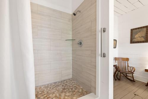 a shower with a glass door in a bathroom at The Historic Island Hotel of Cedar Key in Cedar Key