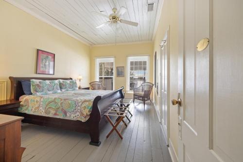 a bedroom with a bed and a ceiling fan at Historic Island Hotel in Cedar Key