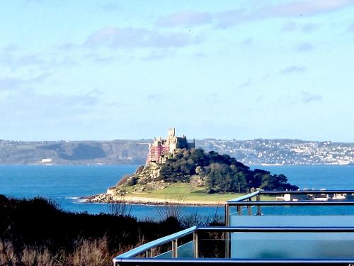 a castle on an island in the water at Great location very spacious. Sea and castle view in Marazion