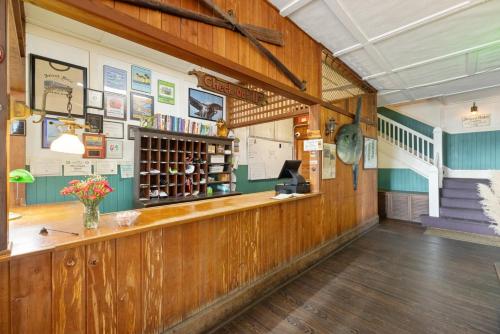 a large room with a counter in a building at Cedar Keys Island Hotel in downtown in Cedar Key