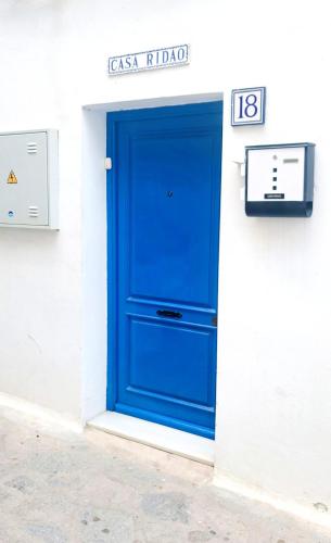 a blue door on the side of a building at Casa Ridao-Habitación Indalo con vistas in Mojácar