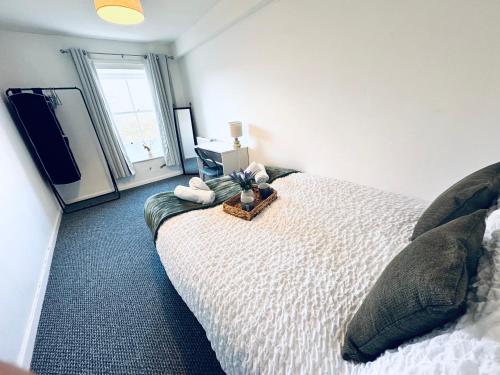 a bedroom with a white bed and a television at The Georgian Townhouse - 4 Bedrooms - Sleeps 9 in Whitehaven