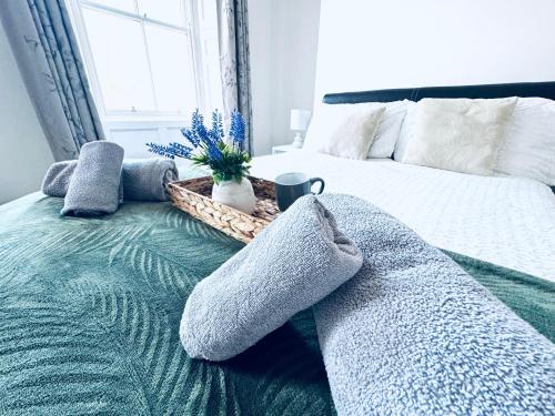 a bedroom with a bed with pillows and a basket on it at The Georgian Townhouse - 4 Bedrooms - Sleeps 9 in Whitehaven