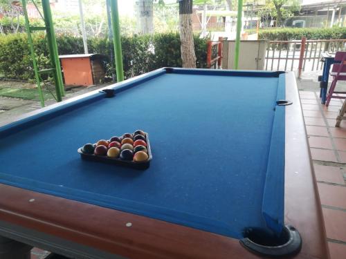 a pool table with a tray of balls on it at Hostal BioHotel Caribe Green in Santa Marta