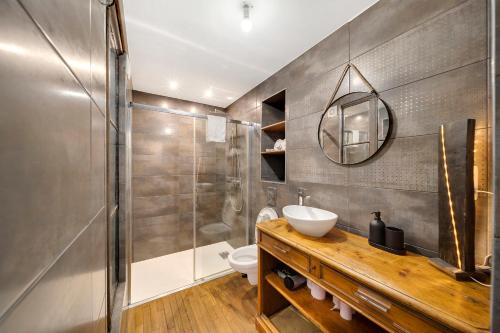 une salle de bain avec un lavabo et une douche dans l'établissement Oenosuite - Charme & Vin en hyper-centre, à Dijon