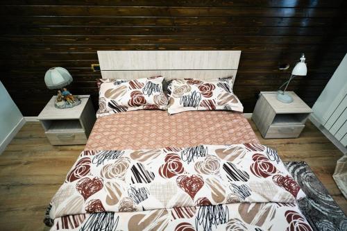 a bedroom with a large bed and two night stands at Cabana Flo in Statiunea Borsa