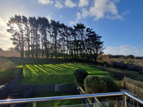 a view of a field of grass with trees at Very Spacious, Great location. Castle and Sea view in Marazion