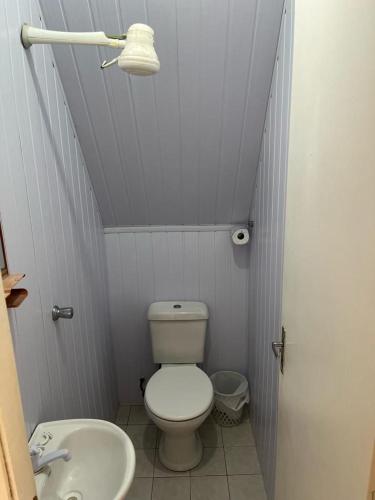 a small bathroom with a toilet and a sink at Chalemar Itanhaém in Itanhaém