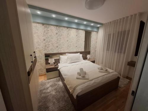 a bedroom with a bed with two towels on it at Astera 2 in Vrnjci