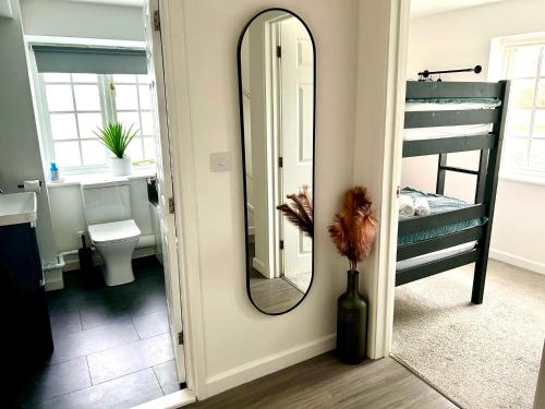 a bathroom with a mirror and a bunk bed at Idyllic location, Amazing view, Spacious in Marazion