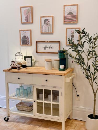 a tea cart in a room with a plant at Chic Living on Newbury Street in Boston