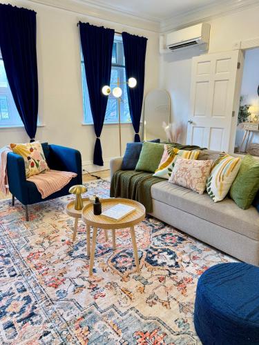 a living room with a couch and a table at Chic Living on Newbury Street in Boston