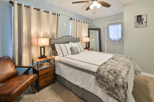 a bedroom with a bed and two lamps and a couch at Sr Pilot Earhart Hangar Suite, 2 br K &Q, 1 Ba in Atchison