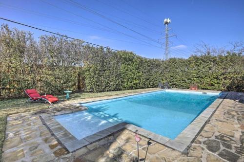 a swimming pool in a yard with a red chair at Texas - Justin 7 in Stafford
