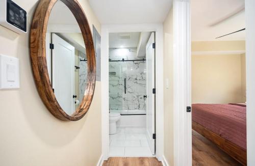 a mirror on a wall next to a bathroom at The Harvard Yard 2 bedroom 1 BathApartment Homes in Atlanta